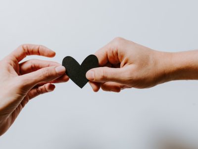 two person holding papercut heart