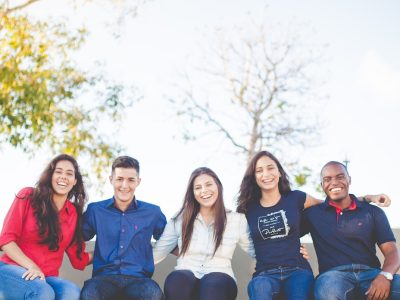 group of people sitting on bench near trees duting daytime