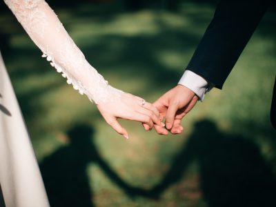 man and woman holding hands focus photo