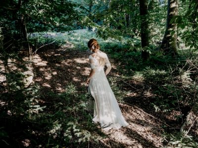 woman in white dress standing on forest during daytime