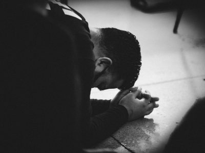 man in black jacket lying on floor