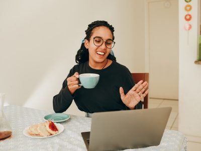 woman in black long sleeve shirt holding white ceramic mug