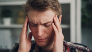 a man holding his hands to his ears